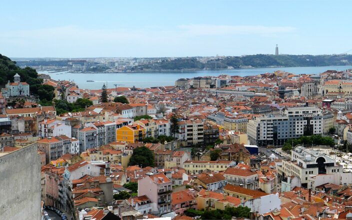 São Jorge Castle overlooks Lisbon’s red rooftops, with the Tagus River, Cristo Rei and 25 de Abril Bridge beyond.